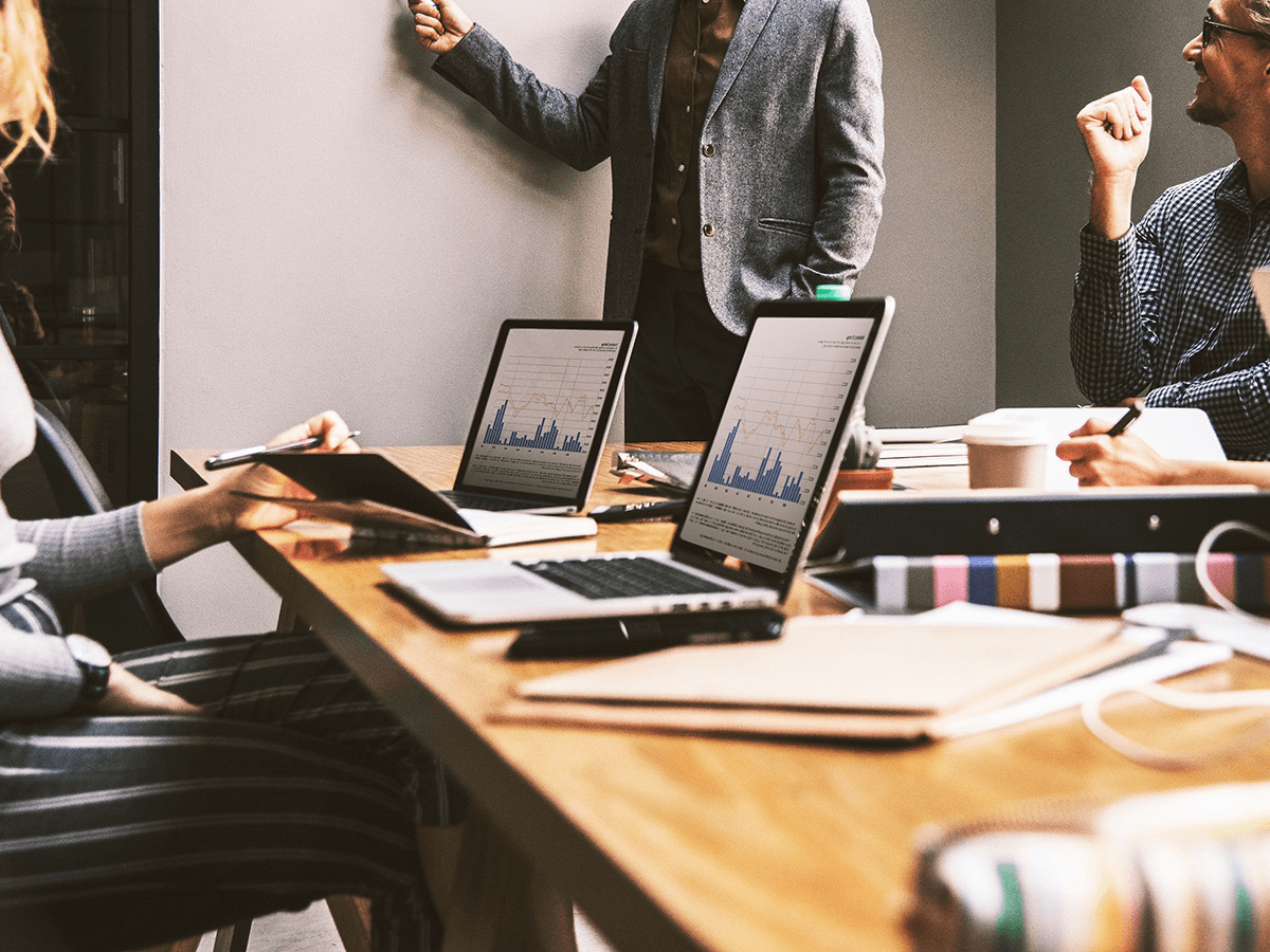 Digital marketing team reviewing key components of SEM campaigns for strategy planning.