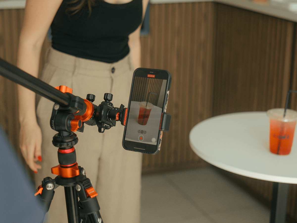 Content creator recording a product with a phone to create high-engagement reels.